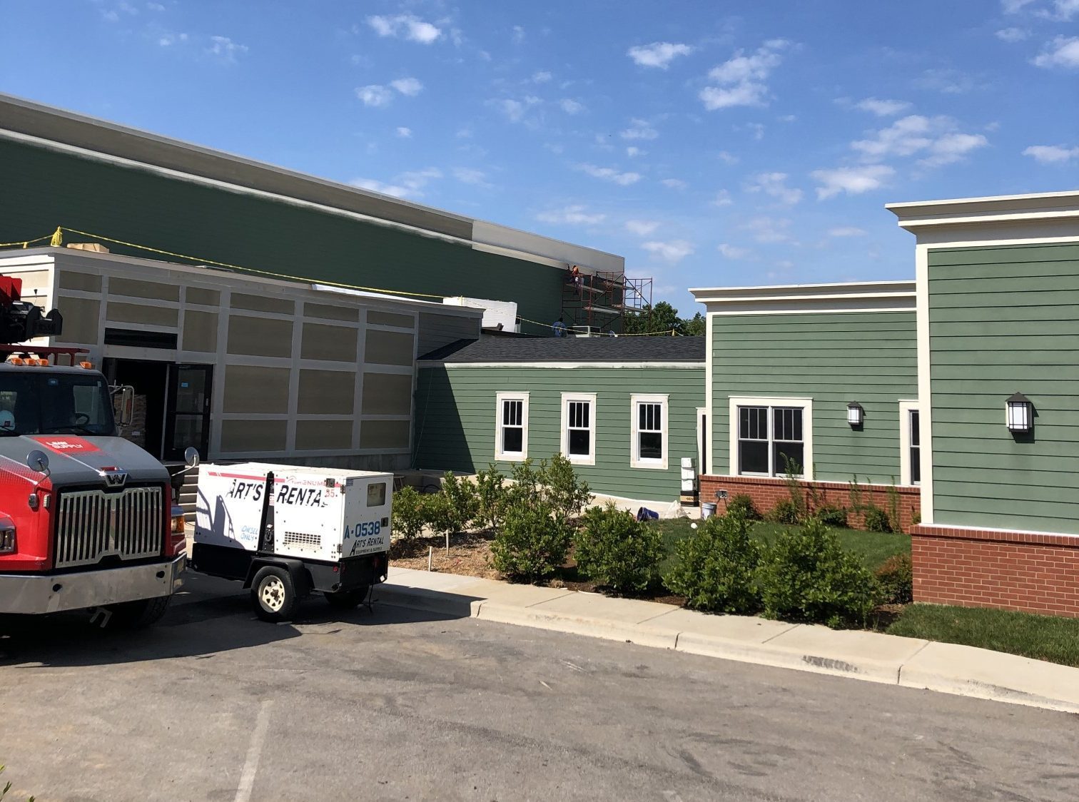 A parked truck positioned in front of a building, highlighting the contrast between the vehicle and the architecture