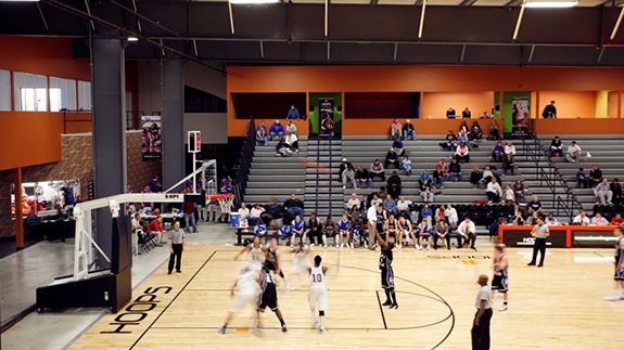  basketball game in progress inside a vibrant indoor arena filled with spectators and players in action